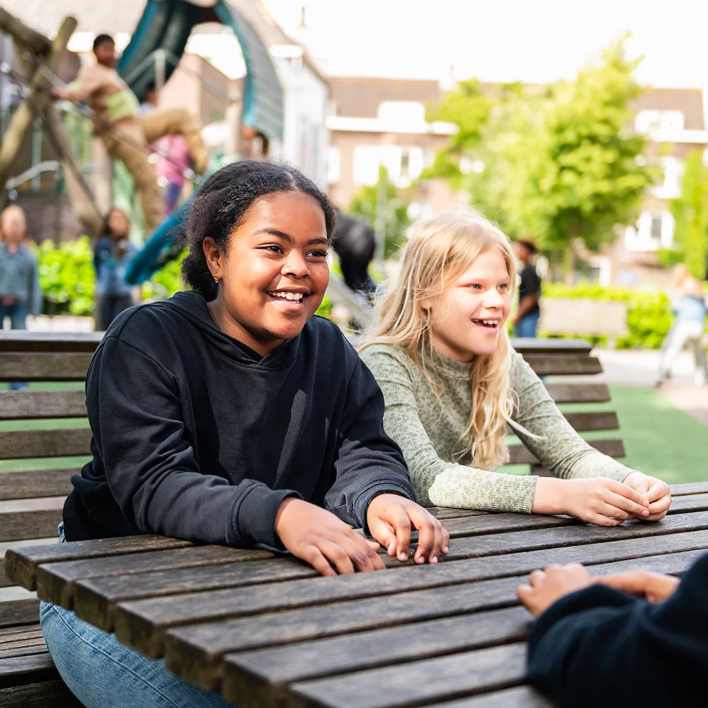 Leerlingen kletsen met elkaar op schoolplein