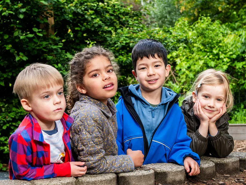leerlingen groep spelen buiten in schooltuin