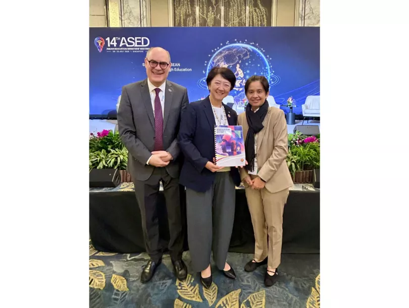 Dr Frank Feulner stands with Ms Maki Katsuno-Hayashikawa, who holds the ASEAN Work Plan on Education 2026–2030, and Amalia M. Serrano at the 14th ASED in Singapore.