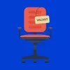An empty office chair with a "Vacant" sign, symbolising an open position within the SCOPE-HE team.
